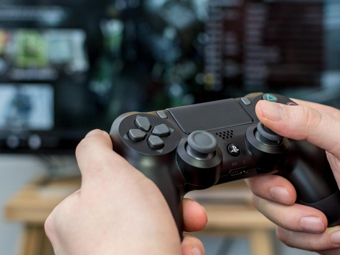 A hand holding a remote control