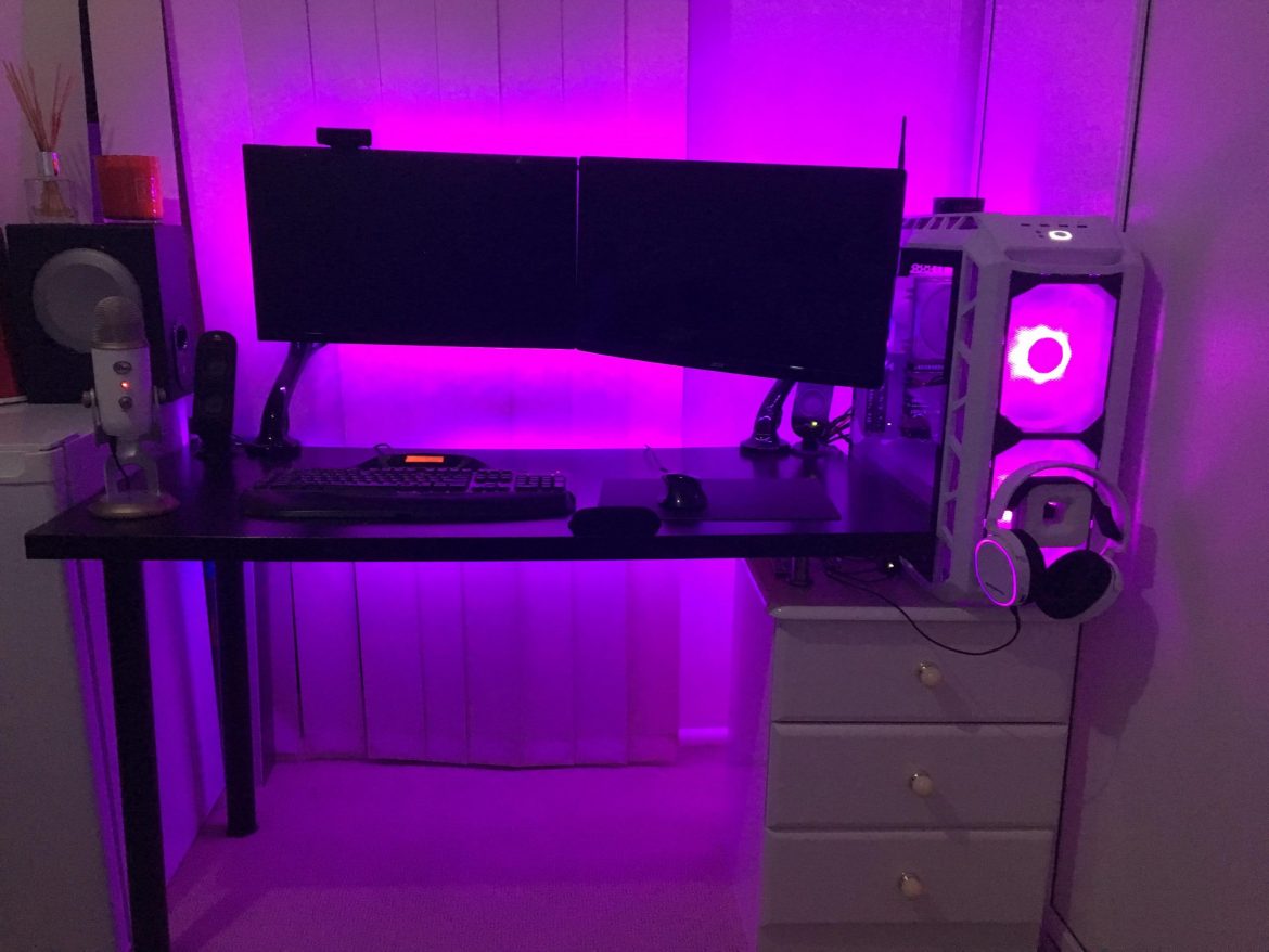 A desktop computer sitting on top of a purple light